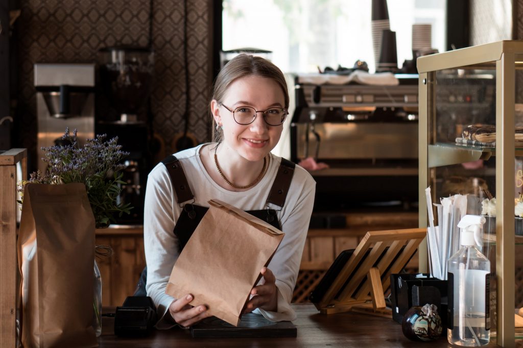 Salesperson in coffeehouse and bakery